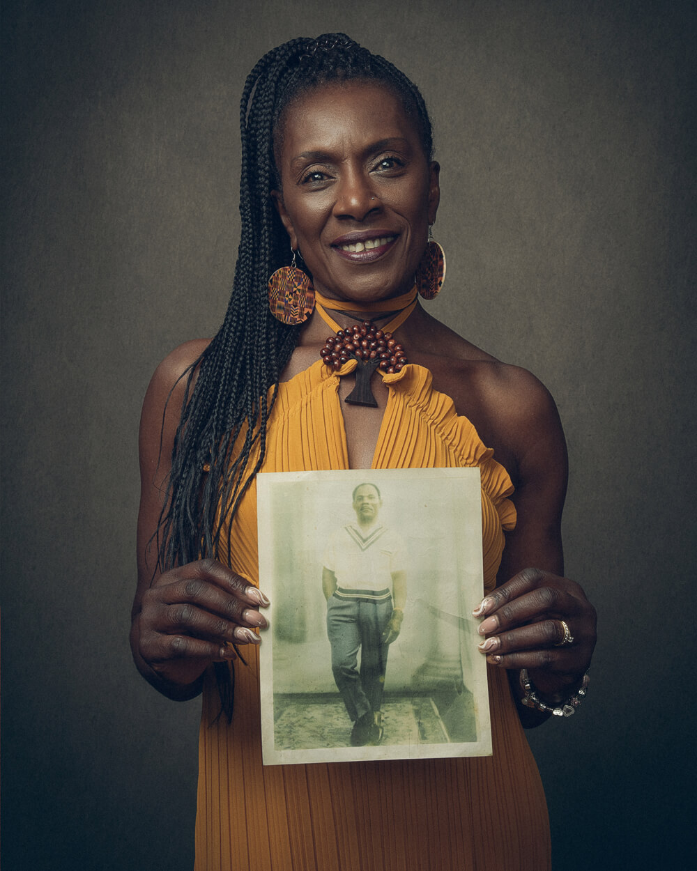A portrait photo of Dorretta Maynard holding a photo