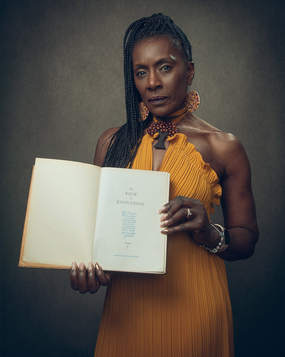 A portrait photo of Dorretta Maynard holding an open book