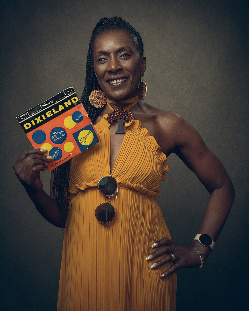 A portrait photo of Dorretta Maynard holding a seven inch Dixieland Record