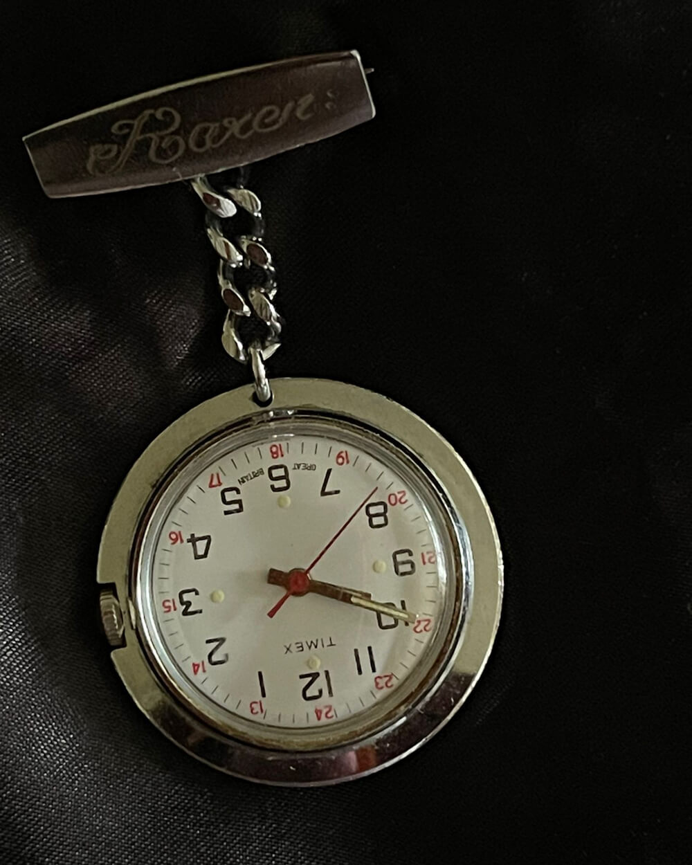 A photo of the front of an old pocket watch with name