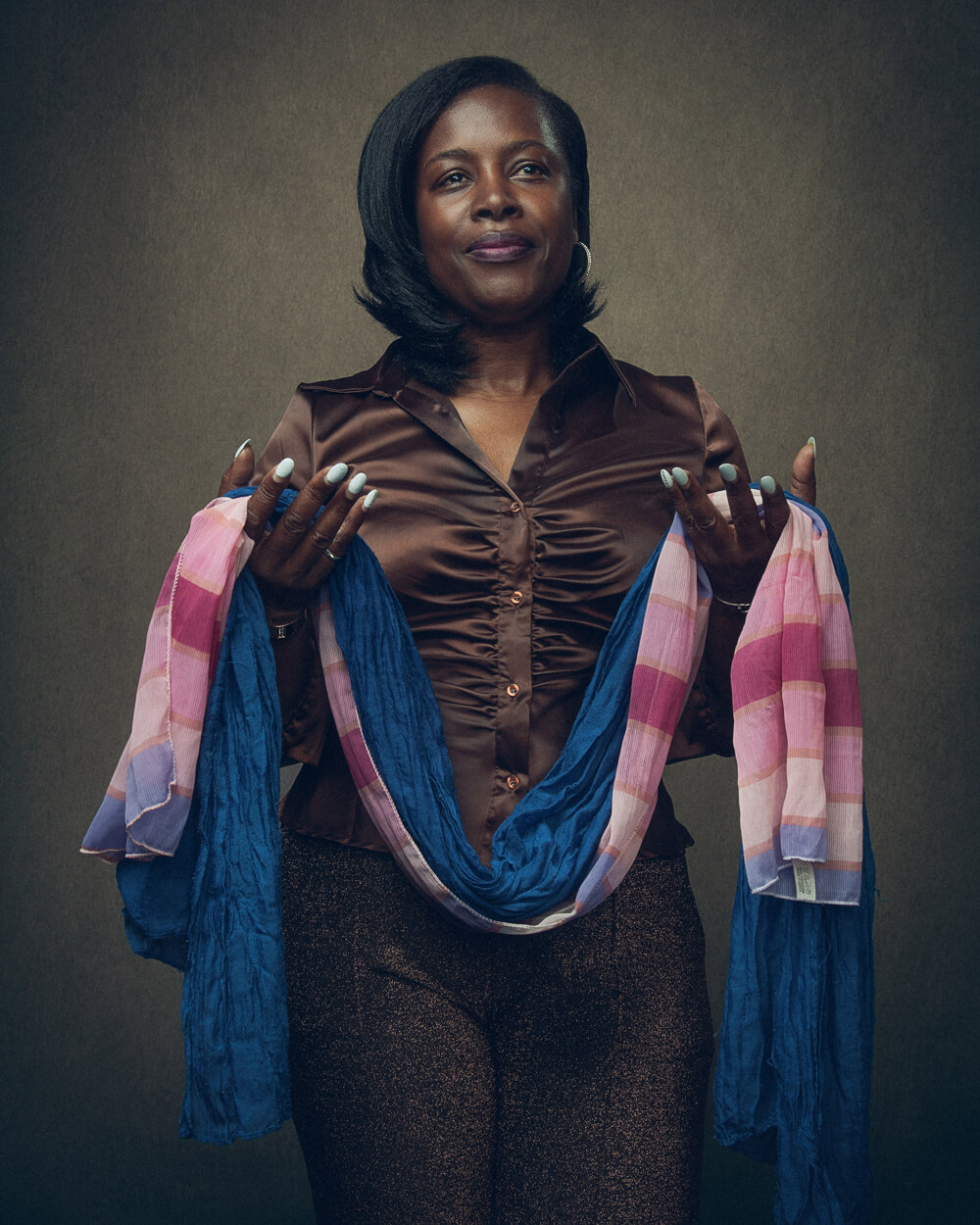 A portrait photo of Sandra Smith holding fabric